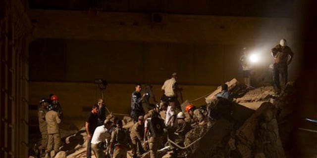 Jan. 25: Rescue workers search for victims after a building collapsed in Rio de Janeiro, Brazil.
