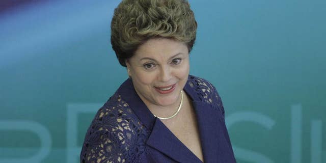 Brazil's President Dilma Rousseff arrives to attend a press conference at the Planalto Presidential Palace, in Brasilia, Brazil, Monday, Dec. 22, 2014. President Rousseff gave one of her last press conferences before the Christmas holiday and talked about various topics, including the recent Petrobras scandal. (AP Photo/Eraldo Peres)