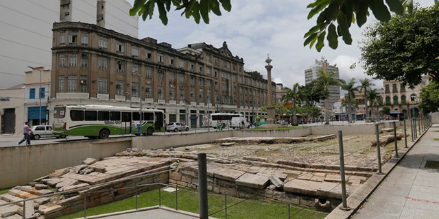 In this Nov. 26, 2015 photo, shows the ruins of the "Cais do Valongo" or "Valongo wharf," in Rio de Janeiro, Brazil. The site is largely inscrutable, even to the trained eye: An open archeological pit, the spot where hundreds of thousands of enslaved Africans debarked after their harrowing journey across the Atlantic is but a collection of jumbled stones, with a three-paragraph-long plaque the sole indicator of the historical significance of the spot. (AP Photo/Silvia Izquierdo)