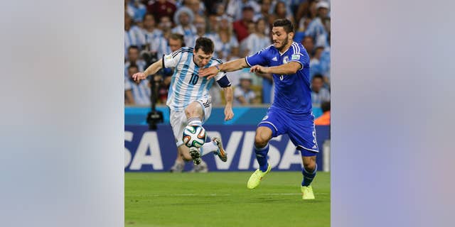 Bosnia's Sead Kolasinac, right, tries to stop Argentina's Lionel Messi (10) during their group F World Cup soccer match at the Maracana Stadium in Rio de Janeiro, Brazil, Sunday, June 15, 2014. (AP Photo/Thanassis Stavrakis)