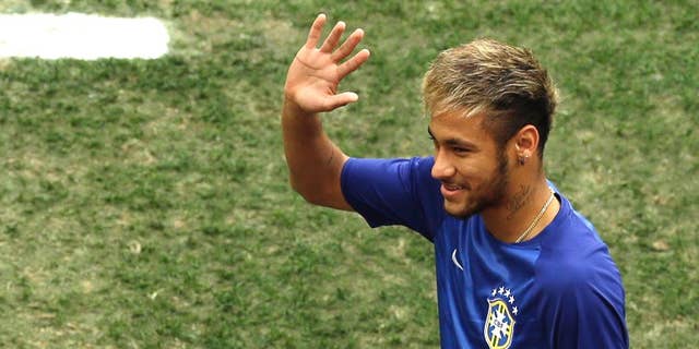 Brazil's Neymar waves as he enters the pitch to sit on the bench before the World Cup third-place soccer match between Brazil and the Netherlands at the Estadio Nacional in Brasilia, Brazil, Saturday, July 12, 2014. (AP Photo/Themba Hadebe)