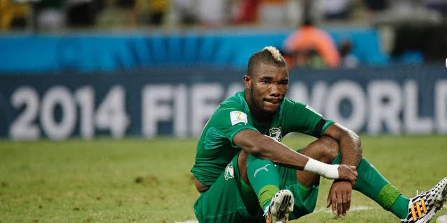 Ivory Coast's Serey Die sits on the pitch after Greece's 2-1 victory over Ivory Coast during the group C World Cup soccer match between Greece and Ivory Coast at the Arena Castelao in Fortaleza, Brazil, Tuesday, June 24, 2014. (AP Photo/Christophe Ena)
