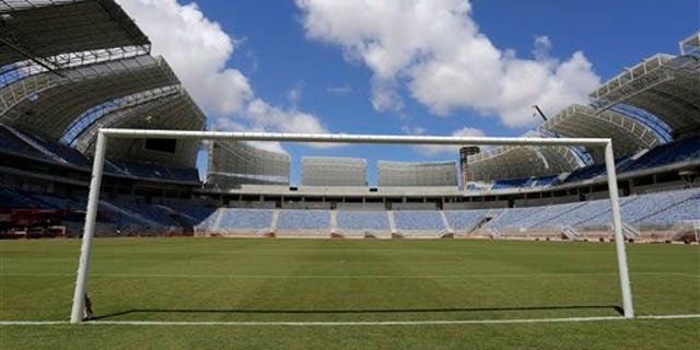 The empty goal stands in the Estadio das Dunas in Natal, Brazil, Friday, Dec. 13, 2013. Four matches of the 2014 soccer World Cup will be played in the stadium. (AP Photo/Ferdinand Ostrop)