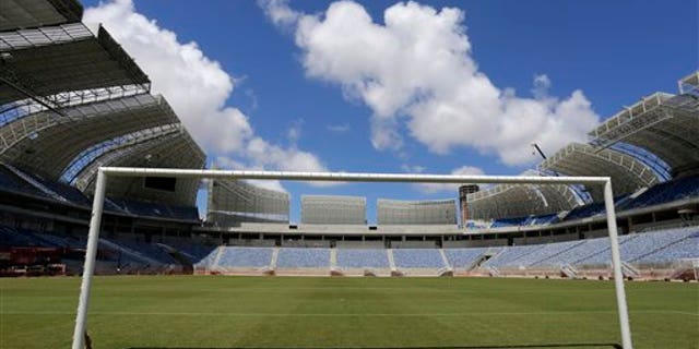 The empty goal stands in the Estadio das Dunas in Natal, Brazil, Friday, Dec. 13, 2013. Four matches of the 2014 soccer World Cup will be played in the stadium. (AP Photo/Ferdinand Ostrop)