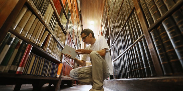 SAO PAULO, BRAZIL - MARCH 12: Philosphy student Sergio Araujo sorts books in a 19th-century library inside Sao Bento Monastery on March 12, 2013 in Sao Paulo, Brazil. The monastery is said to be the oldest institution in Sao Paulo; Benedictines arrived at the site in 1598. Pope Benedict XVI visited Sao Bento in 2007. Brazil has more Catholics than any other country in the world and supporters hope Sao Paulo Archbishop Cardinal Odilo Pedro Scherer will be chosen as the next Pope during the papal conclave. (Photo by Mario Tama/Getty Images)