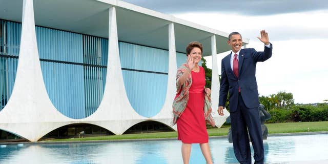 FILE - In this March 19, 2011, file photo, U.S. President Barack Obama walks with Brazilian President Dilma Vana Rousseff as he arrives at the Palacio do Alvorada in Brasilia, Brazil. Brazilian President Dilma Rousseff's office said on Tuesday, March 25, 2015, that she has again been invited to make a state visit to Washington, two years after she declined a similar invitation to protest an American spy program. (AP Photo/Susan Walsh, File)