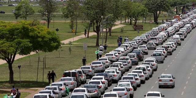 Taxi drivers protest against the online transportation service Uber, in Brasilia, Brazil, Tuesday, Nov. 8, 2016. More than 1 thousand taxi drivers, many in their vehicles, staged a protest in front of Congress demanding that it prohibits the U.S. based company from operating in Latin America's largest nation. (AP Photo/Eraldo Peres)
