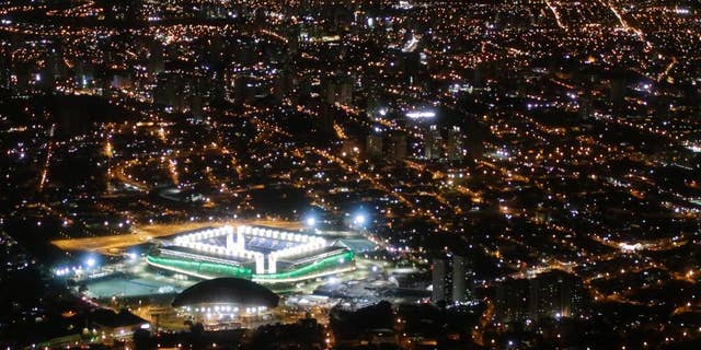 FILE - In this June 24, 2014 file photo, a night aerial view of the Arena Pantanal stadium in Cuiaba, Brazil.  The new stadium in the western Brazilian city is being closed for "emergency repairs" just seven months after it held four World Cup matches. (AP Photo/Felipe Dana, File)