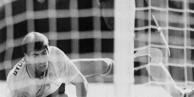 FILE - In this June 22, 1994, file photo, Colombia's Andres Escobar, lies on the ground and watches a shot by America's Eric Wynalda miss the Colombian goal, during the World Cup match, in the Rose Bowl, Pasadena. The Unites States defeated Colombia by two goals to one. Escobar was shot six times by a man employed by two drug traffickers, who had been complaining to him about his blunder 10 days earlier in Los Angeles. Escobar had knocked Colombia out of contention by kicking the ball into his own net in game against the United States. (AP Photo/Draper, File)