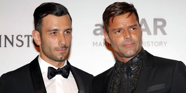 Singer Ricky Martin, right, and artist Jwan Yosef pose on the red carpet of The Foundation for AIDS Research (amfAR) event in Sao Paulo, Brazil, Friday, April 15, 2016. 