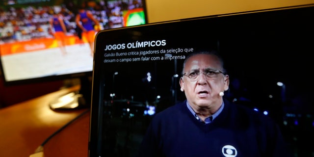 Carlos Eduardo dos Santos Galvao Bueno, chief sports commentator for Globo, is seen on a screen in Rio de Janeiro, Brazil, Monday, Aug. 15, 2016. When a BBC announcer suggested that the Brazilian broadcaster needed to shut up at the start of a swimming race at the Rio Olympics, he was voicing the feelings of many in the host country. Considered the Bob Costas of Brazil, Carlos Eduardo dos Santos Galvao Bueno, known here simply as Galvao, is a love-him-or-hate-him announcer who is the voice of Brazilian sports. His raucous, over-the-top style helps make big sporting events feel even bigger in Brazil. (AP Photo/Silvia Izquierdo)
