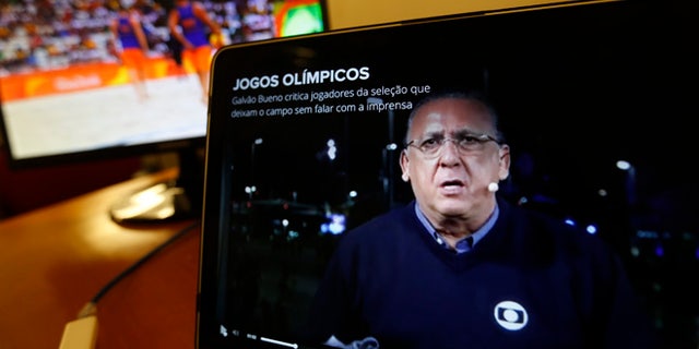Carlos Eduardo dos Santos Galvao Bueno, chief sports commentator for Globo, is seen on a screen in Rio de Janeiro, Brazil, Monday, Aug. 15, 2016. When a BBC announcer suggested that the Brazilian broadcaster needed to shut up at the start of a swimming race at the Rio Olympics, he was voicing the feelings of many in the host country. Considered the Bob Costas of Brazil, Carlos Eduardo dos Santos Galvao Bueno, known here simply as Galvao, is a love-him-or-hate-him announcer who is the voice of Brazilian sports. His raucous, over-the-top style helps make big sporting events feel even bigger in Brazil. (AP Photo/Silvia Izquierdo)
