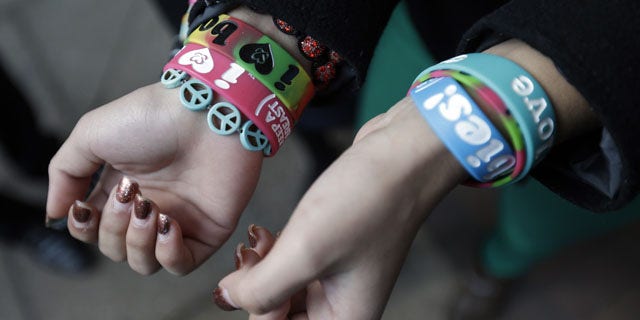 FILE - In this Feb. 20, 2013 file photo, Easton Area School District students Brianna Hawk, 15, left, and Kayla Martinez, 14, display their "I (heart) Boobies!" bracelets for photographers outside the U.S. Courthouse in Philadelphia. (AP Photo)