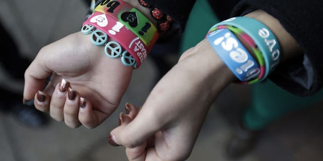 FILE - In this Feb. 20, 2013 file photo, Easton Area School District students Brianna Hawk, 15, left, and Kayla Martinez, 14, display their "I (heart) Boobies!" bracelets for photographers outside the U.S. Courthouse in Philadelphia. (AP Photo)