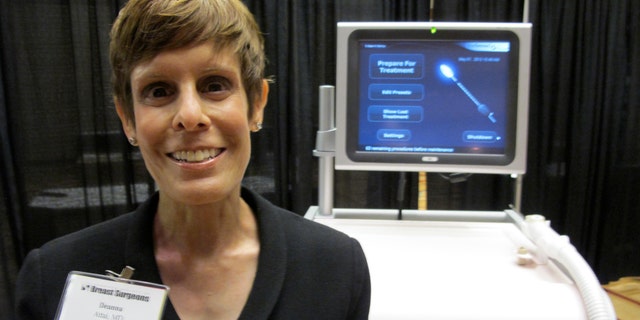 Dr. Deanna Attai, who is on the board of directors for American Society of Breast Surgeons, stands in front of cryoablation machine at the American Society of Breast Surgeons conference on May 1, 2013 in Chicago.