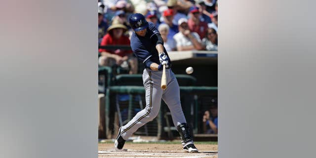 Milwaukee Brewers' Ryan Braun hits an RBI double during the first inning of a spring exhibition baseball game against the Texas Rangers Friday, March 21, 2014, in Surprise, Ariz. (AP Photo/Darron Cummings)