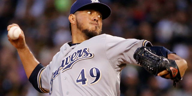 FILE - In this Sept. 19, 2014, file photo, Milwaukee Brewers starting pitcher Yovani Gallardo delivers during the first inning of a baseball game against the Pittsburgh Pirates in Pittsburgh. A person familiar with the deal told The Associated Press, Monday, Jan. 19, 2015, the Milwaukee Brewers have agreed to trade starter Gallardo to the Texas Rangers. (AP Photo/Gene J. Puskar, File)