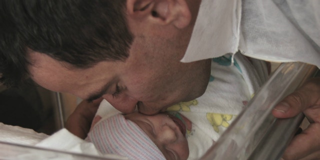 Brian Lande and his newborn son.