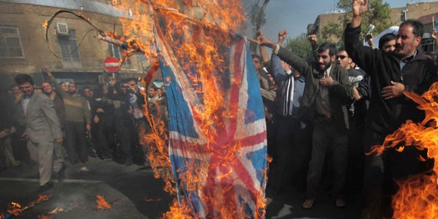Nov. 4: Iranian protestors burn representative of the British flag during an anti-British demonstration in front of the British Embassy in Tehran, Iran.