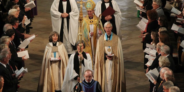 March 21, 2013: The new Archbishop of Canterbury Justin Welby, centre, arrives for his enthronement service at Canterbury Cathedral in Canterbury England.