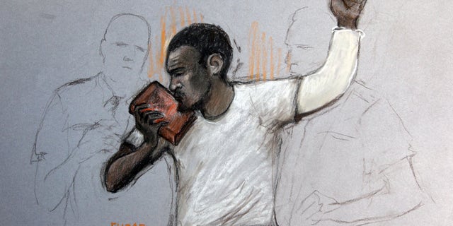 June 3, 2013 - In this court artist sketch by Elizabeth Cook, suspect Michael Adebolajo kisses the Koran, as he appears at Westminster Magistrates Court, London.