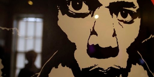 A vintage concert poster depicting late US musician Jimi Hendrix, is seen in a exhibition at the Handel House Museum, in central London's Mayfair area. (AP)