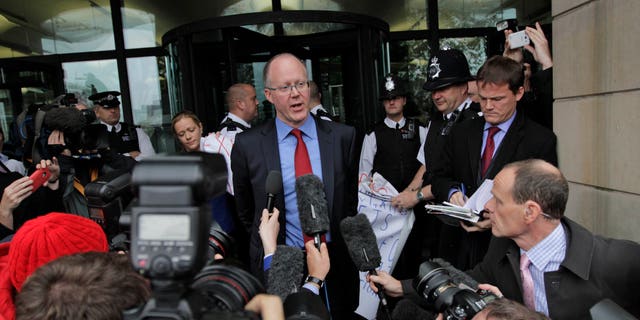 Oct. 23. 2012: George Entwistle, center, the British Broadcasting Corporation (BBC) Director General, talks to members of the media, as he departs Portcullis house in central London.