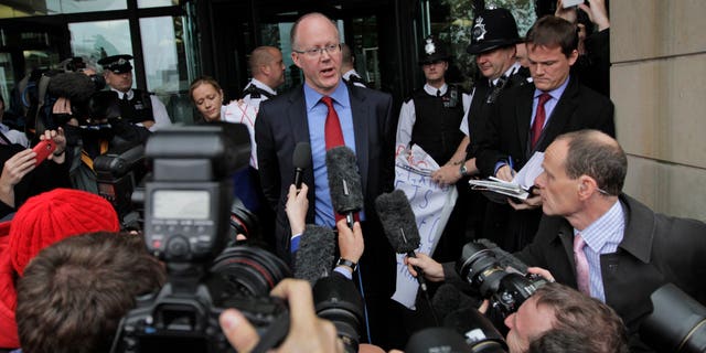 Oct. 23. 2012: George Entwistle, center, the British Broadcasting Corporation (BBC) Director General, talks to members of the media, as he departs Portcullis house in central London.