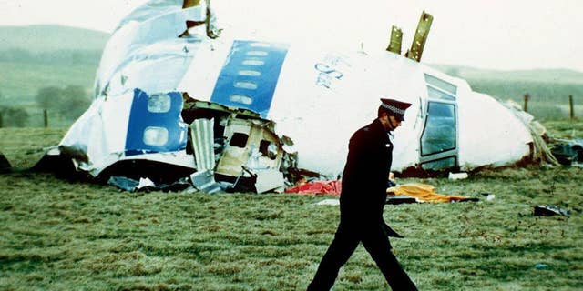 a police officer walks by the nose of Pan Am flight 103 in Lockerbie, Scotland, where it lay after a bomb aboard exploded, killing a total of 270 people.