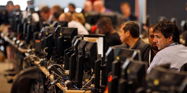 July 3, 2012: Technology experts work in London 2012 Olympic games Technology Operations Centre (TOC) in London's Canary Wharf financial district.