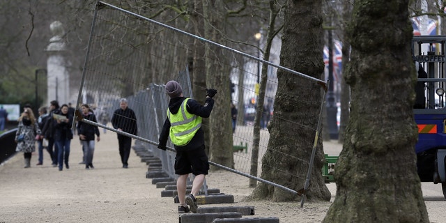 April 18, 2013 - Workers put up fencing in the Mall near Buckingham Palace as preparations begin for the London Marathon. The Marathon will go ahead on Sunday despite security fears in the wake of the bomb blasts in Boston.