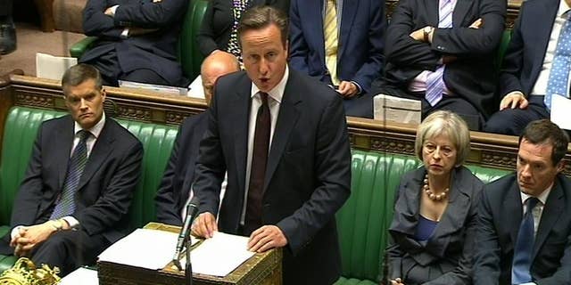 In this image taken from TV, Britain's Prime Minister David Cameron makes a statement at the House of Commons, London, Monday Sept. 7, 2015. David Cameron says the U.K. will re-settle up to 20,000 Syrian refugees from camps in Turkey, Jordan and Syria over the next five years. (PA via AP) UNITED KINGDOM OUT NO SALES NO ARCHIVE