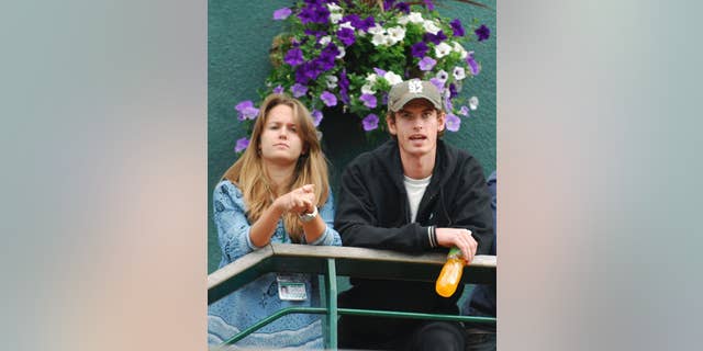FILE - In this file photo dated Friday June 29, 2007, Britain's Andy Murray stands with his girlfriend Kim Sears, as they look out from a balcony at Wimbledon, in London. Murray has got engaged to his long-term girlfriend Kim Sears, his agent has confirmed Wednesday Nov. 26, 2014. (AP Photo/Odd Andersen) EDITORIAL USE ONLY