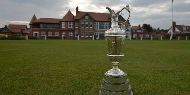 The British Open Golf trophy the "Claret Jug" is displayed by the clubhouse at the Royal Liverpool Golf Club before the British Open golf championships, Hoylake, England, Wednesday, April 22, 2014. The tournament begins on Thursday July 17, 2014. (AP Photo/Jon Super)