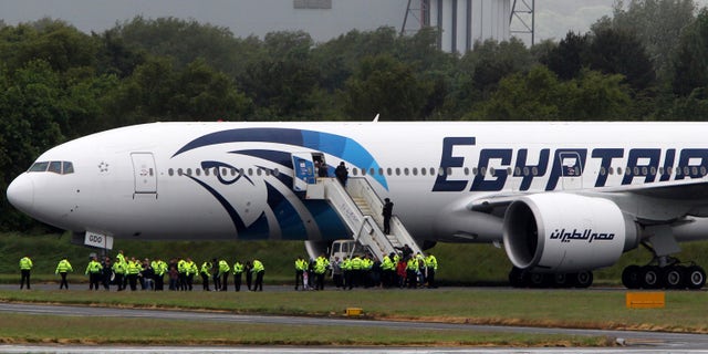 June 15, 2013: Passengers leave the Egyptair aircraft at Prestwick Airport, Scotland, after it was diverted while en route from Cairo to New York. It is reported that BBC employee Nada Tafik, who was on board the plane, said she found a note in a toilet apparently threatening to start a fire.
