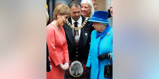 Britain's Queen Elizabeth II meets First Minister of Scotland Nicola Sturgeon, left, as she arrives at the opening ceremony for the Borders Railway route at Tweedbank station, Scotland, Wednesday Sept. 9, 2015. The Queen has today become the longest ever reigning monarch in British history surpassing Queen Victoria who served for 63 years and seven months. Danny Lawson / PA via AP) UNITED KINGDOM OUT - NO SALES - NO ARCHIVES