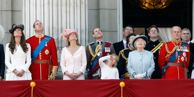 June 11, 2011: Britain's Duchess of Cambridge, Prince William the Duke of Cambridge, Countess of Wessex Sophie, Prince Edward the Earl of Wessex, their daughter Louise, Princess Anne, partially seen, her husband Tim Lawrence, Britain's Queen Elizabeth II, Prince Harry, Prince Philip the Duke of Edinburgh, and Prince Andrew, watch a Royal Air Force flypast on the balcony of Buckingham Palace.