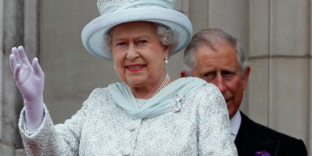 Queen Elizabeth waves from the balcony at Buckingham Palace during the Diamond Jubilee celebrations in central London, in a June 2012 image.