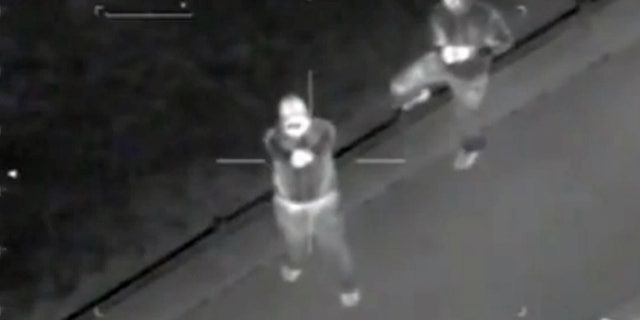 This infra-red video still image taken from a police helicopter issued by West Midlands Police on Saturday Aug. 20 2011 shows what the police say are hooded youths firing shots at the helicopter during the riots in Birmingham, central England on August 9. The force said 11 shots were fired. Chief Constable Chris Sims called it "a concerted and organized attempt to kill or injure police officers."