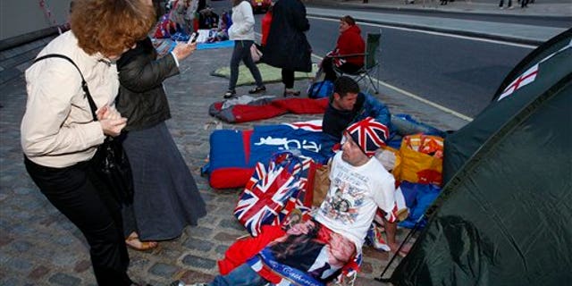 April 26: John Loughrey, a fan of Princess Diana, talks with a passer-by outside Westminster Abbey in London. (AP)