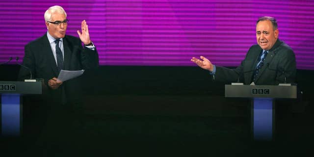 Better Together leader Alistair Darling, left, and Scotland's First Minister, Alex Salmond, both gesture whilst they take part in the second television debate over Scottish independence at Kelvingrove Art Gallery and Museum in Glasgow, Scotland, Monday Aug. 25, 2014. (AP Photo/PA, David Cheskin) UNITED KINGDOM OUT NO SALES NO ARCHIVE