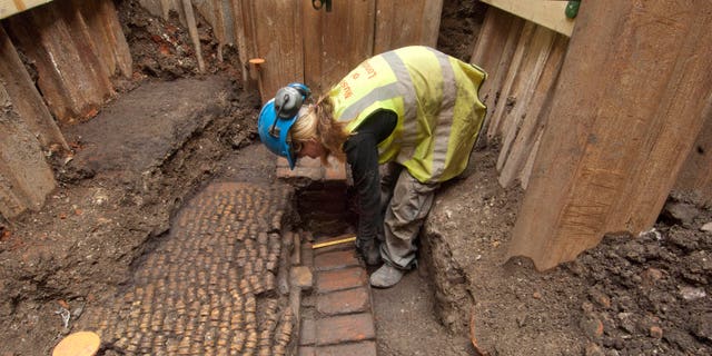 June 6, 2012: An archaeologist undertakes initial excavation work at the site of The Curtain Theatre in London in October 2011.