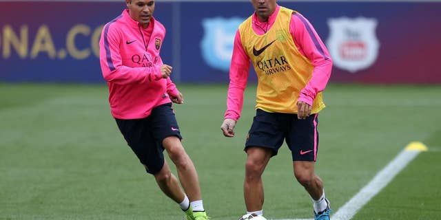 Barcelona's Xavi, right, and Andres Iniesta, run, during a pre-season training session, at St George's Park, Burton-Upon-Trent, England, Friday Aug. 1, 2014. (AP Photo/PA, Simon Cooper) UNITED KINGDOM OUT