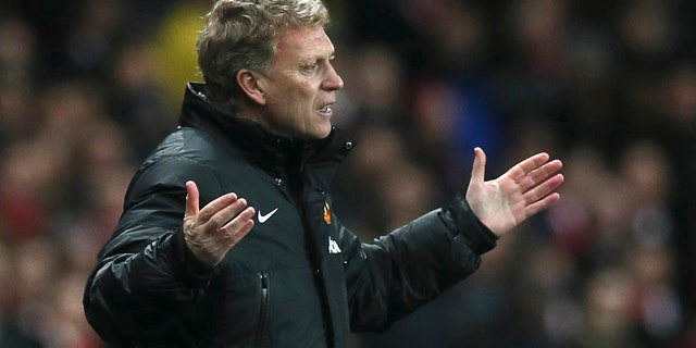 FILE - In this Wednesday, Feb. 12, 2014 file photo Manchester United's manager David Moyes gestures to his team during their English Premier League soccer match between Arsenal and Manchester United at the Emirates stadium in London. Manchester United says manager David Moyes has left the Premier League club after less than a year in charge, amid heavy speculation he was about to be fired. (AP Photo/Alastair Grant, File)