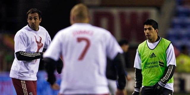 Dec. 21, 2011: Liverpool's Luis Suarez, right, warms up with teammates wearing Luis Suarez shirts before their English Premier League soccer match against Wigan at DW Stadium, Wigan, England.