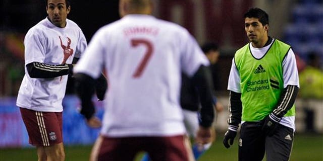 Dec. 21, 2011: Liverpool's Luis Suarez, right, warms up with teammates wearing Luis Suarez shirts before their English Premier League soccer match against Wigan at DW Stadium, Wigan, England.
