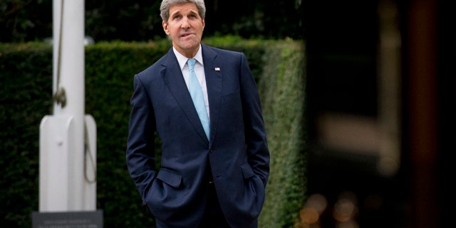 November 18, 2014: U.S. Secretary of State John Kerry waits for the arrival of Oman Foreign Minister Yusuf Bin Alawi bin Abdullah for their meeting at the official residence of the U.S. ambassador to Britain, Winfield House, in London. (AP Photo/Matt Dunham)