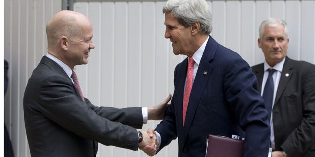 September 9, 2013: British Foreign Secretary William Hague, left, greets US Secretary of State John Kerry outside the Foreign Office in London. (AP Photo)