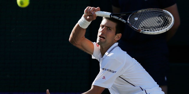 July 6, 2014: Novak Djokovic of Serbia plays a return to Roger Federer of Switzerland during their men's singles final match at the All England Lawn Tennis Championships in Wimbledon, London. (AP)