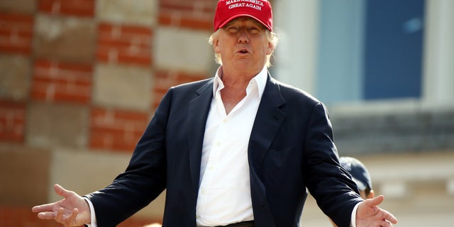 Presidential contender Donald Trump, speaks to the media after arriving by helicopter during the 1st first day of the Women's British Open golf championship on the Turnberry golf course in Turnberry, Scotland, Thursday, July 30, 2015. (AP Photo/Scott Heppell)
